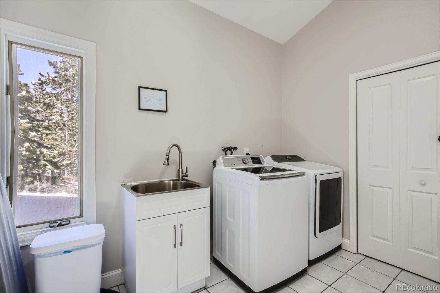27732 Squaw Pass Road Evergreen, CO 80439 - Photo 20 of 33 a view of a storage and utility room with washer and dryer