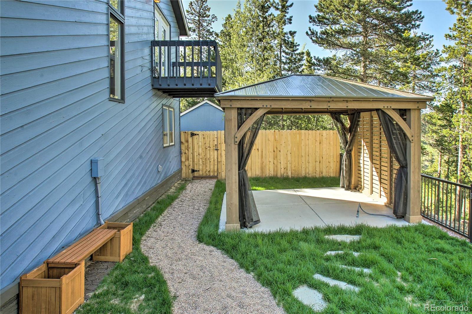 27732 Squaw Pass Road Evergreen, CO 80439 - Photo 22 of 33 a front view of a house with garden
