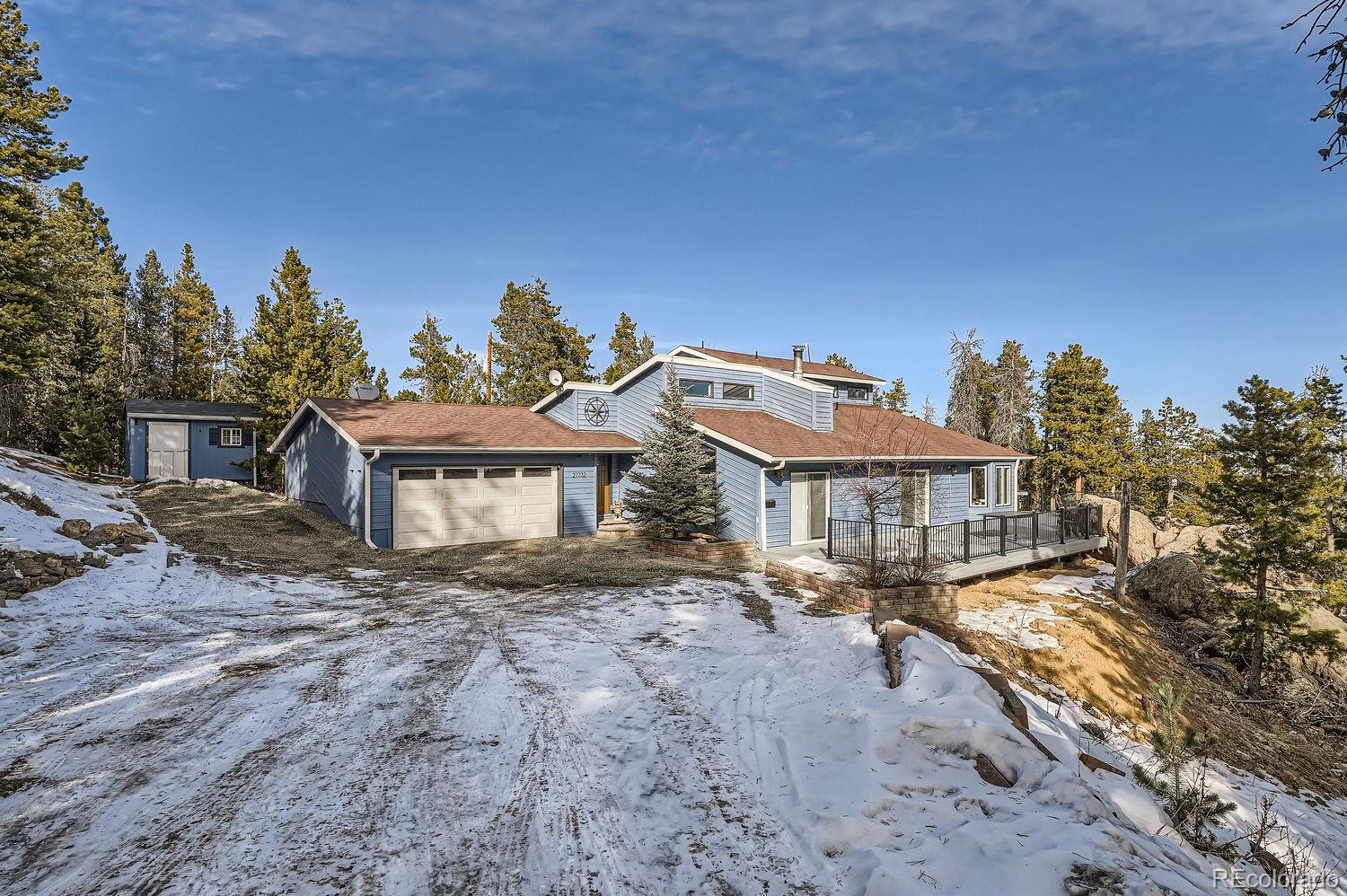 27732 Squaw Pass Road Evergreen, CO 80439 - Photo 29 of 33 a view of a big house with a big yard and large tree