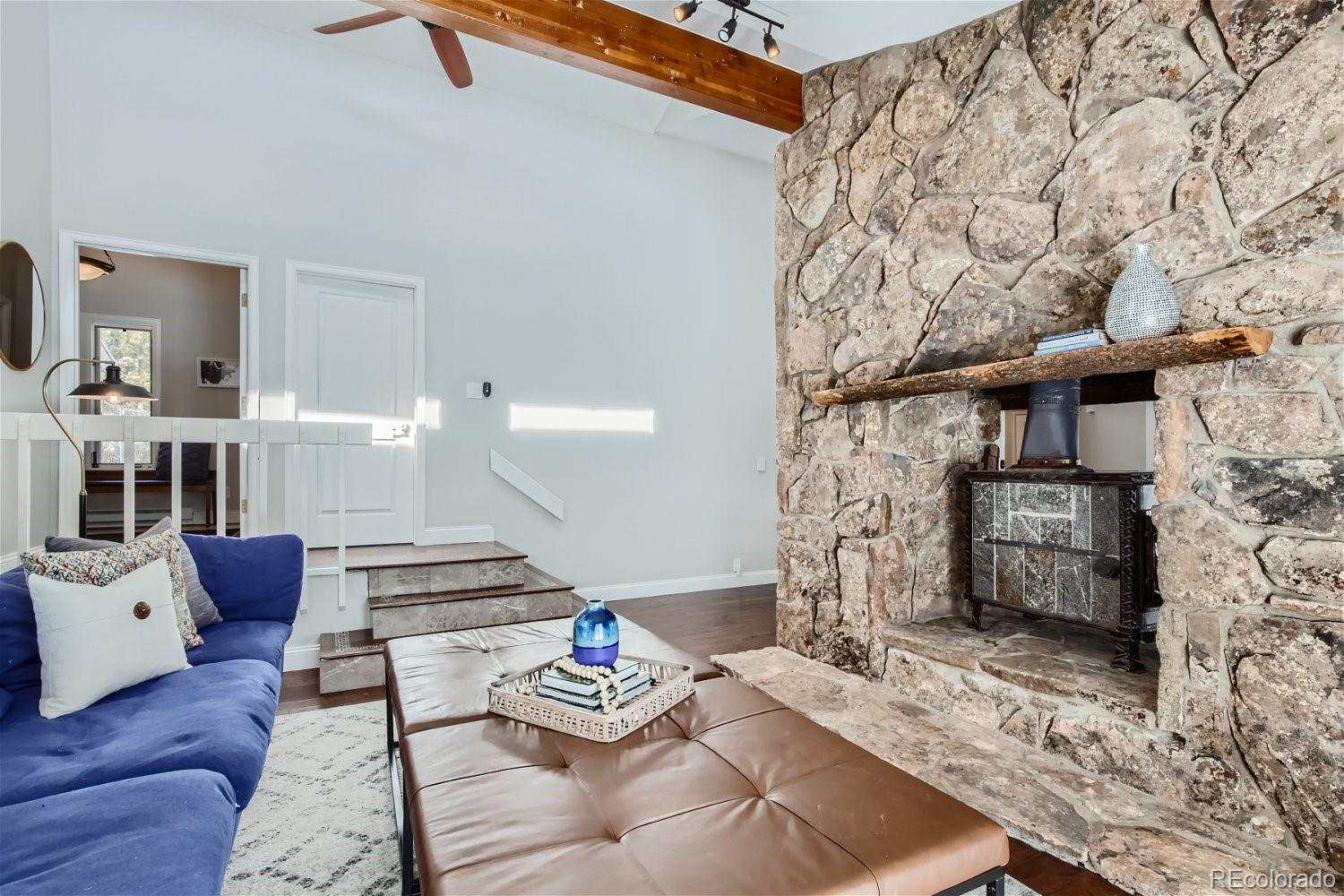 27732 Squaw Pass Road Evergreen, CO 80439 - Photo 4 of 33 a living room with furniture and wooden floor