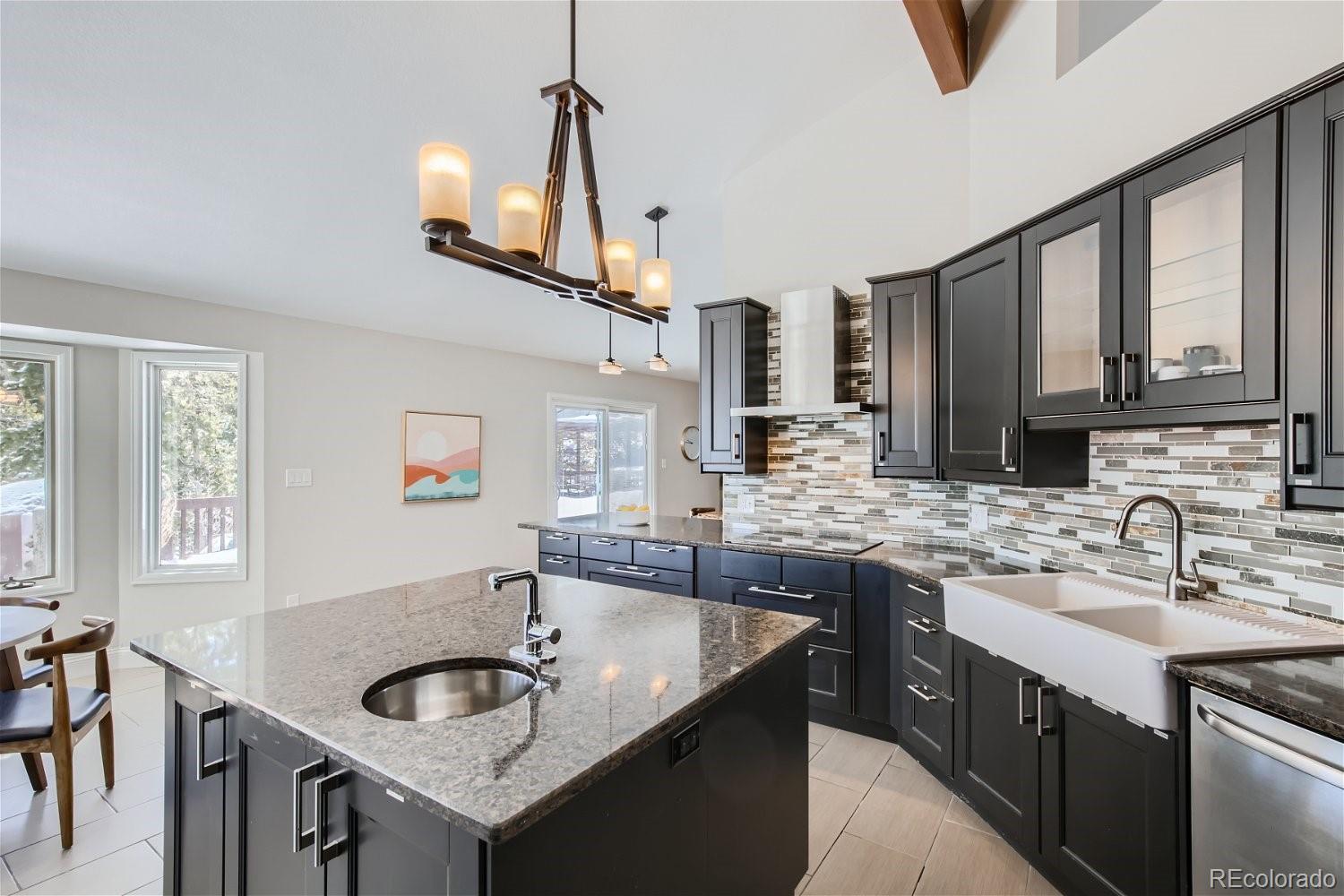 27732 Squaw Pass Road Evergreen, CO 80439 - Photo 6 of 33 a kitchen with stainless steel appliances granite countertop a sink and a refrigerator