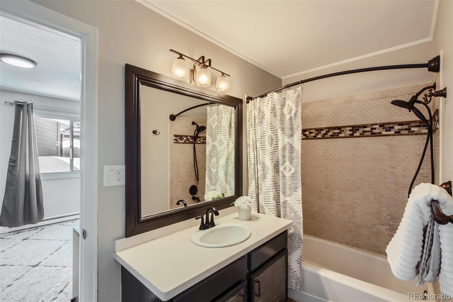 27732 Squaw Pass Road Evergreen, CO 80439 - Photo 10 of 33 a bathroom with a sink and a mirror