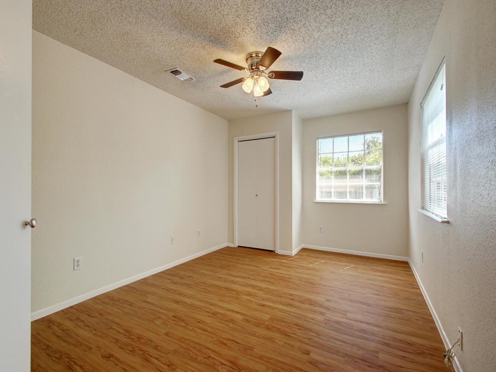 4906 Duval Street, Unit A Austin, TX 78751 - Photo 14 of 24 a view of an empty room with wooden floor and a window
