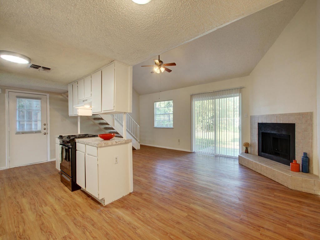 4906 Duval Street, Unit A Austin, TX 78751 - Photo 4 of 24 a kitchen with wooden floors and white walls
