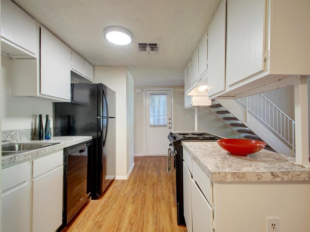 4906 Duval Street, Unit A Austin, TX 78751 - Photo 5 of 24 a kitchen with stainless steel appliances granite countertop a sink a stove and refrigerator