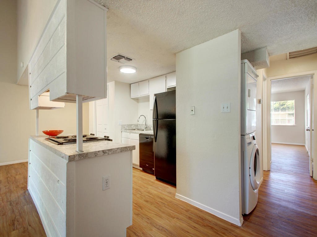 4906 Duval Street, Unit A Austin, TX 78751 - Photo 7 of 24 a kitchen with stainless steel appliances a stove refrigerator and wooden floor