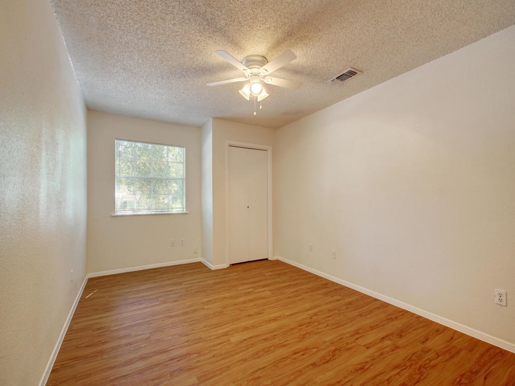 4906 Duval Street, Unit A Austin, TX 78751 - Photo 9 of 24 a view of an empty room with wooden floor and a window