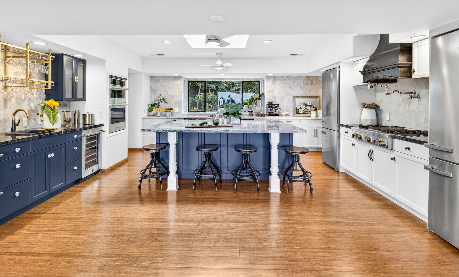 56-2878 Puakea Bay Road Kamuela, HI 96743 - Photo 12 of 25 a kitchen with stainless steel appliances granite countertop a stove top oven a sink a dining table and chairs with wooden floor
