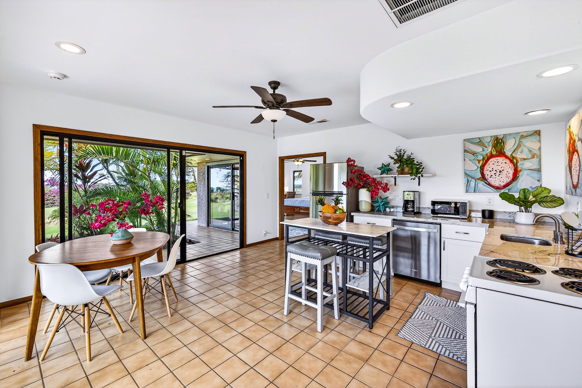 56-2878 Puakea Bay Road Kamuela, HI 96743 - Photo 22 of 25 a dining room with furniture a rug and a floor to ceiling window
