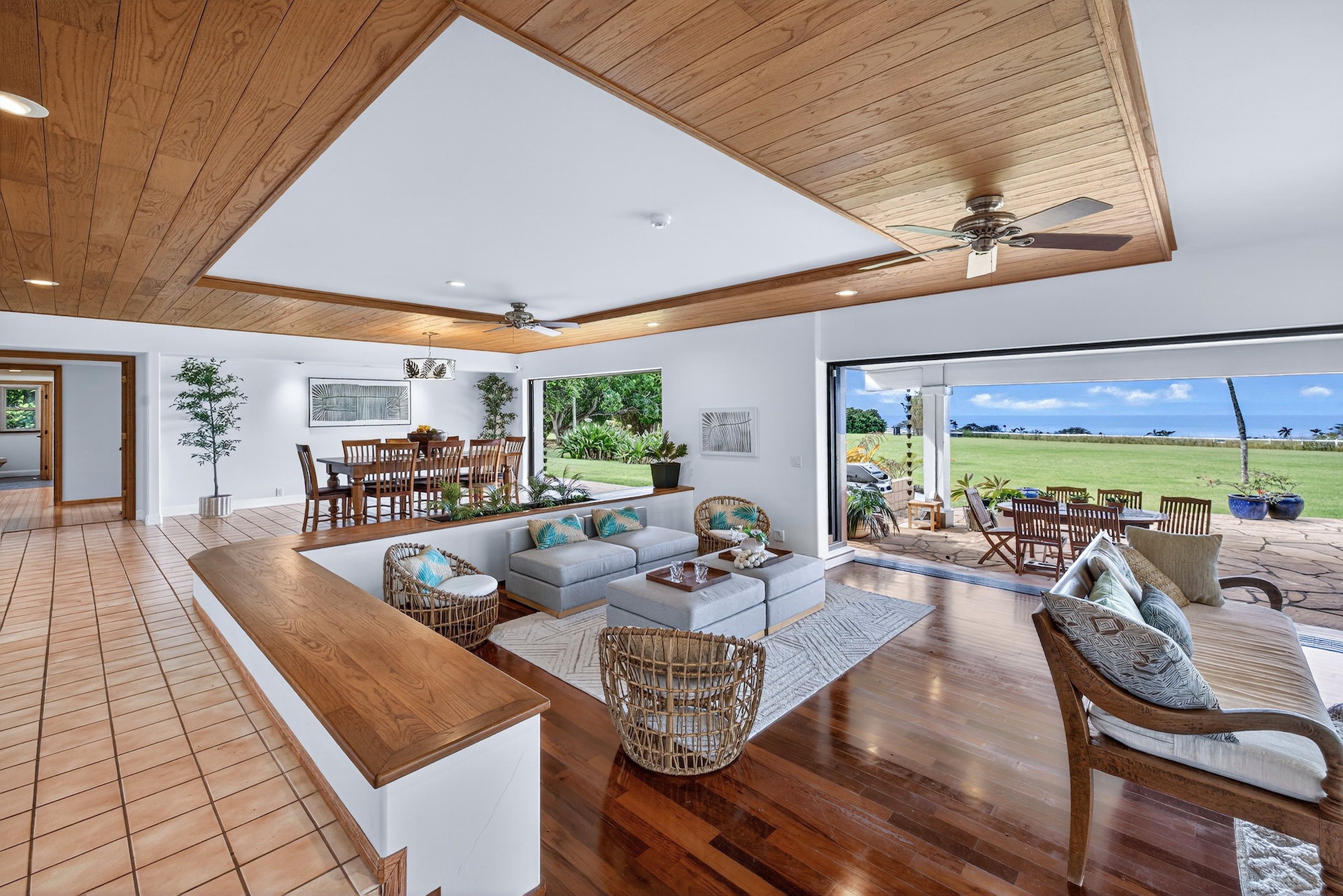 56-2878 Puakea Bay Road Kamuela, HI 96743 - Photo 6 of 25 a view of a living room and dining room with furniture wooden floor and chandelier