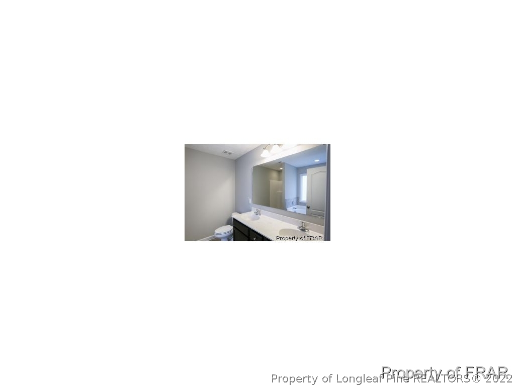 3381 Thrower Road Hope Mills, NC 28348 - Photo 10 of 14 a bathroom with a sink and a mirror
