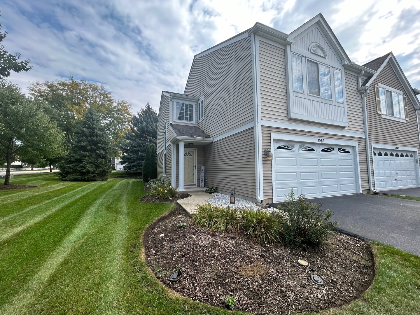 1561 Spaulding Road Bartlett, IL 60103 - Photo 2 of 25 a front view of a house with a yard