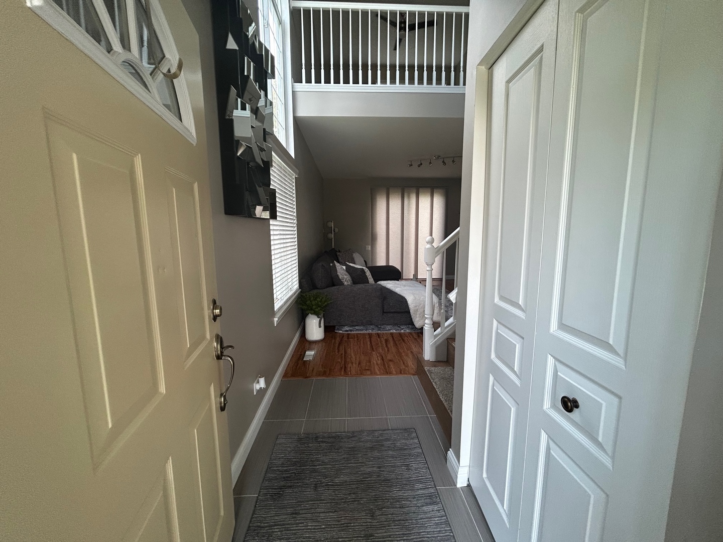 1561 Spaulding Road Bartlett, IL 60103 - Photo 4 of 25 a view of a hallway with wooden floor and staircase