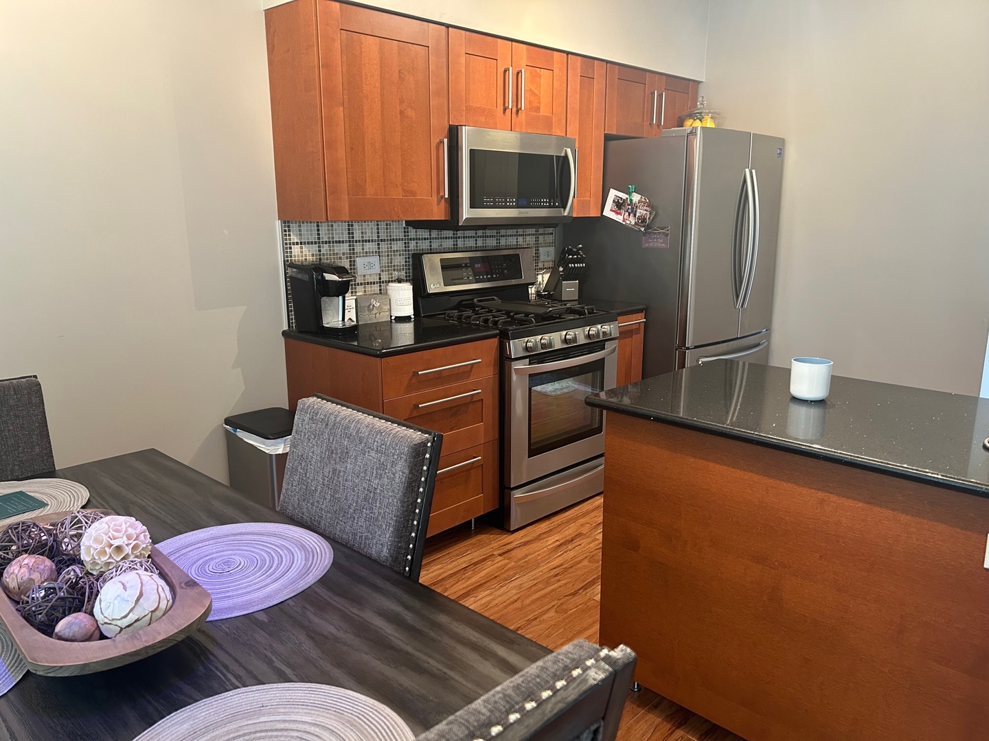 1561 Spaulding Road Bartlett, IL 60103 - Photo 10 of 25 a kitchen with stainless steel appliances wooden cabinets and a stove top oven