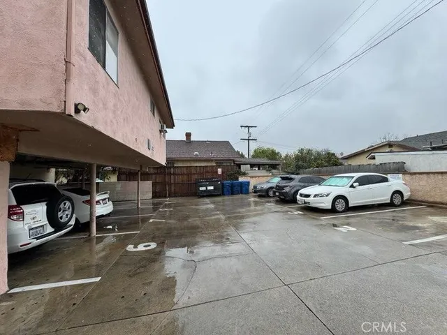 a view of a cars park in front of a building