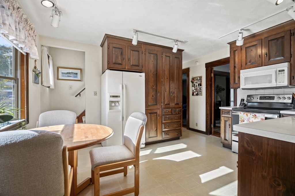 212 Elm Street Amesbury, MA 01913 - Photo 13 of 41 a living room with stainless steel appliances furniture a dining table and chairs