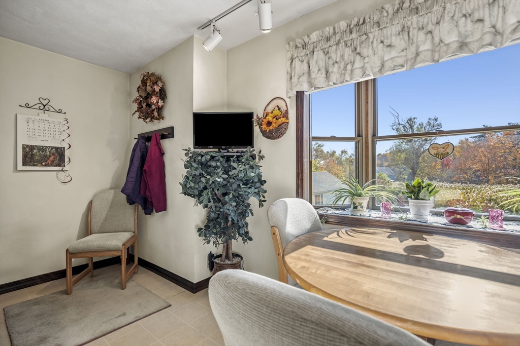 212 Elm Street Amesbury, MA 01913 - Photo 18 of 41 a living room with furniture a flat screen tv and a large window