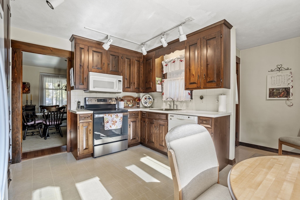 212 Elm Street Amesbury, MA 01913 - Photo 19 of 41 a kitchen with a refrigerator stove top oven and sink
