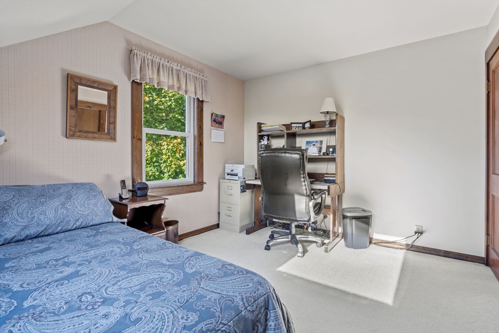 212 Elm Street Amesbury, MA 01913 - Photo 20 of 41 a bedroom with a bed and a chair