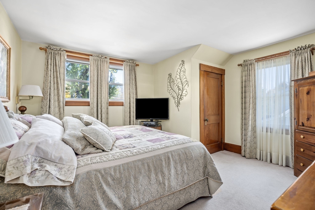 212 Elm Street Amesbury, MA 01913 - Photo 25 of 41 a bedroom with a bed and a flat screen tv