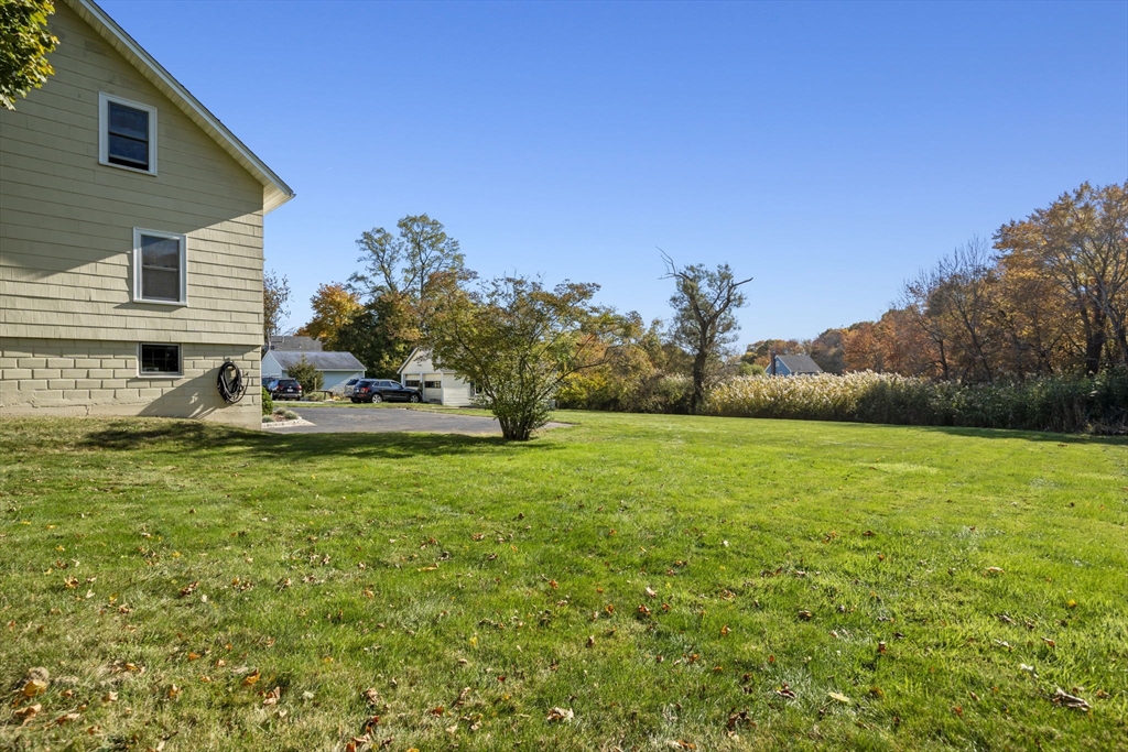 212 Elm Street Amesbury, MA 01913 - Photo 36 of 41 a front view of a house with garden