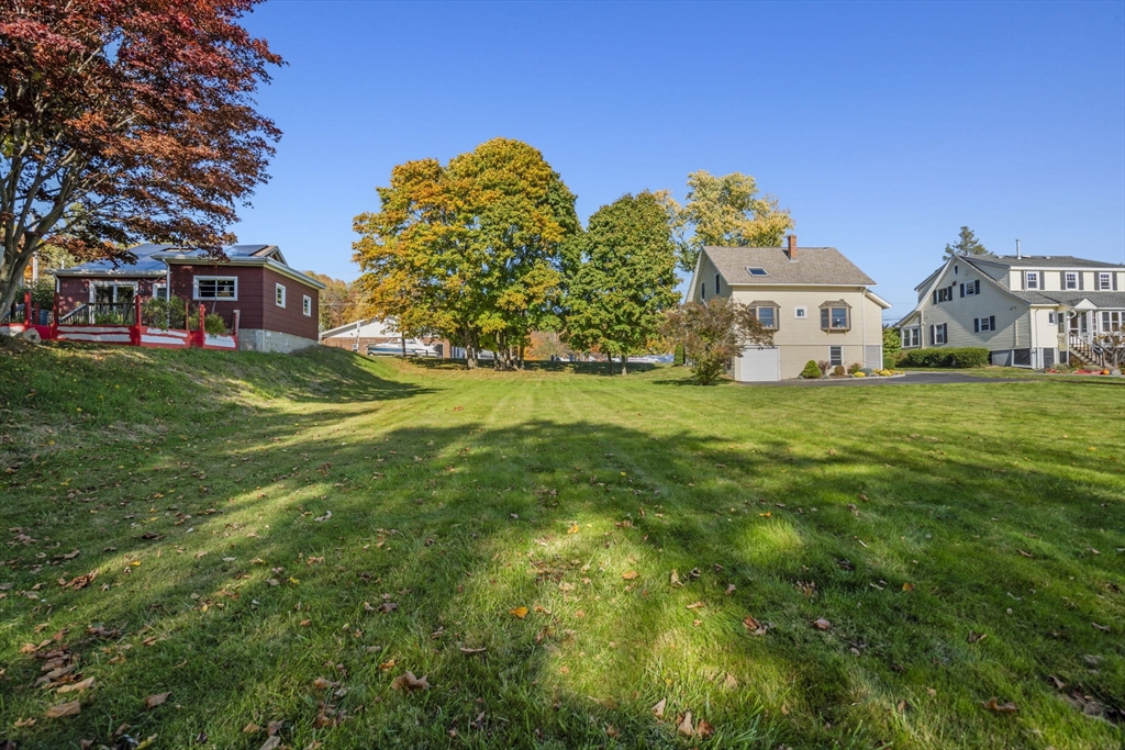 212 Elm Street Amesbury, MA 01913 - Photo 37 of 41 a front view of a house with a garden