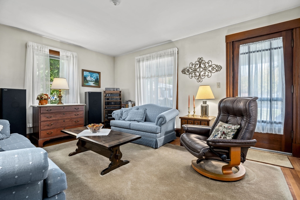 212 Elm Street Amesbury, MA 01913 - Photo 5 of 41 a living room with furniture a wooden floor and a window