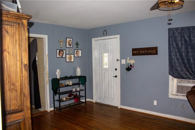 a view of a livingroom with wooden floor and a window