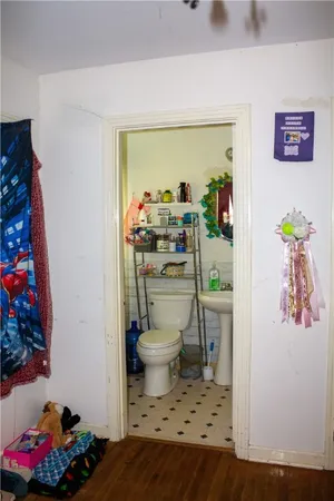 a bathroom with a toilet a sink and a mirror