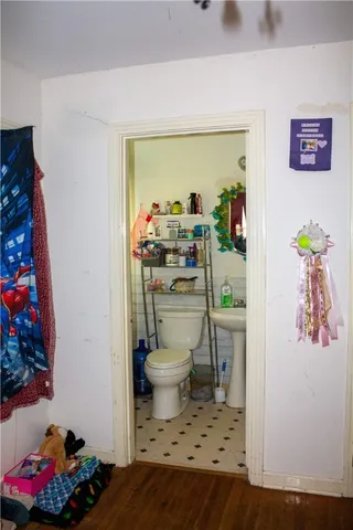 a bathroom with a toilet a sink and a mirror