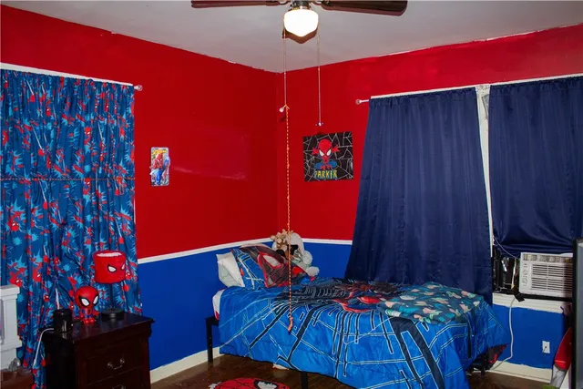 a bedroom with furniture and a lamp