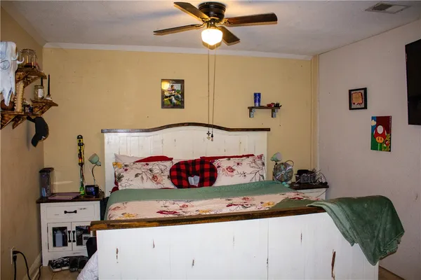 a bedroom with a bed and a chandelier