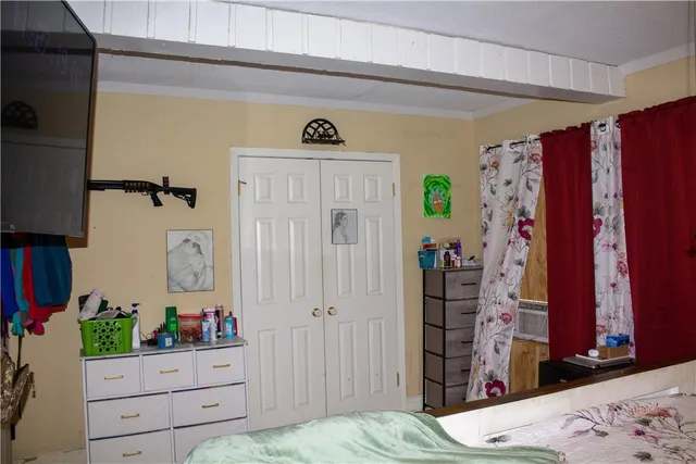 a bedroom with a bed and a dresser in it