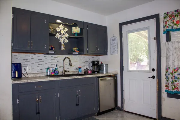 a kitchen with a sink cabinets and a window