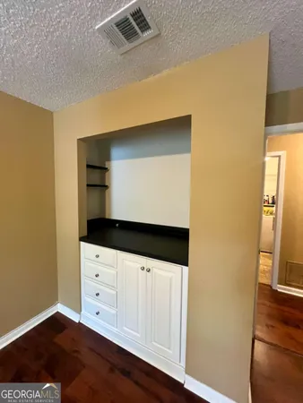 a view of an empty room and wooden floor