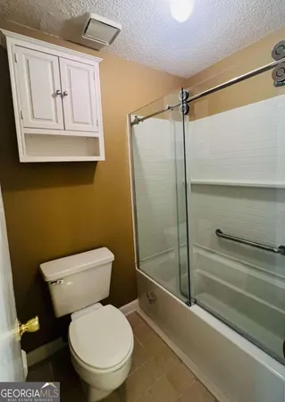 a white toilet sitting next to a bathroom sink