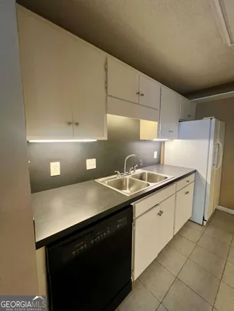 a kitchen with a sink and cabinets