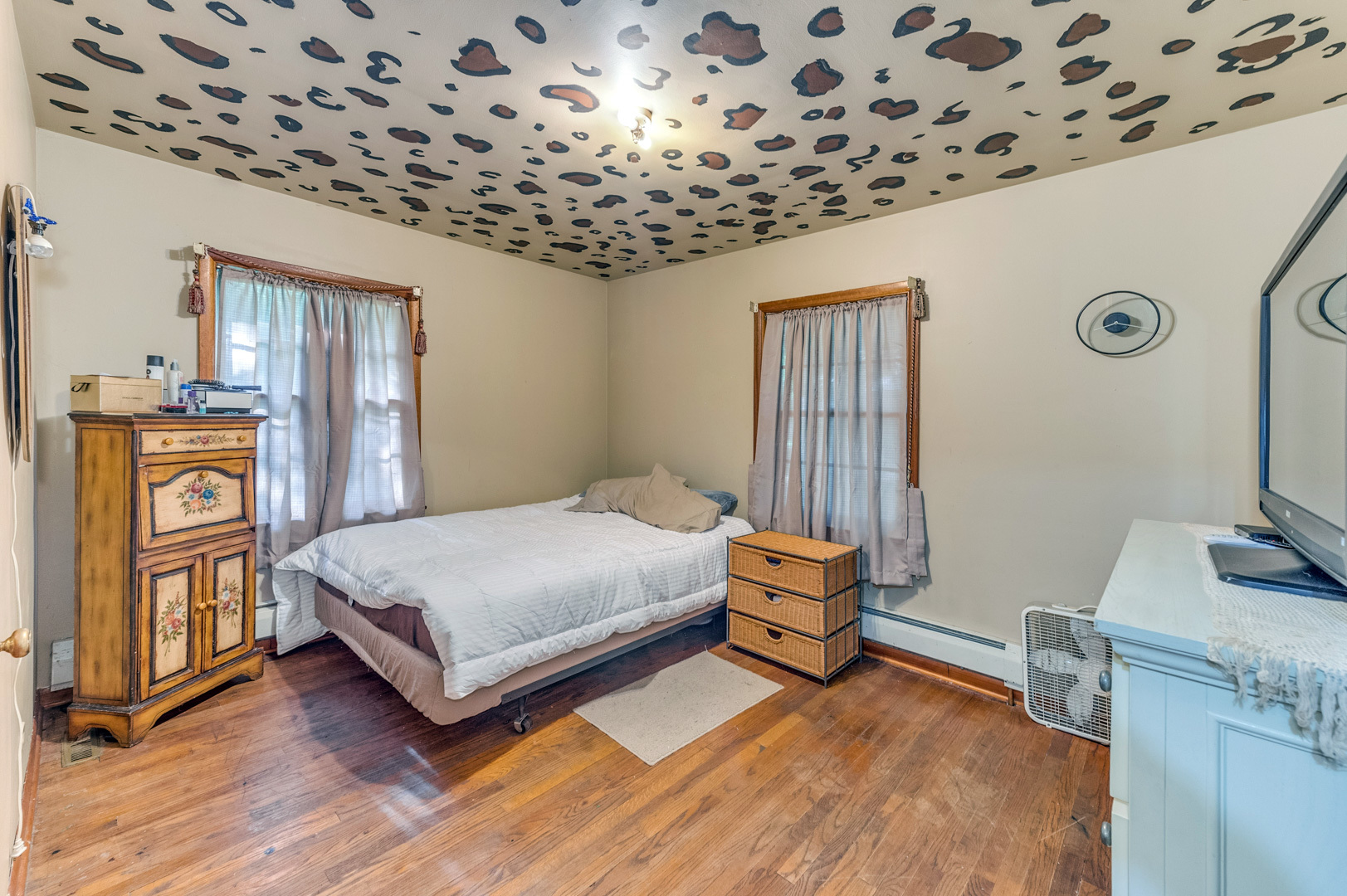810 Parkside Road Naperville, IL 60540 - Photo 16 of 24 a bedroom with a bed and a flat tv screen on the dresser