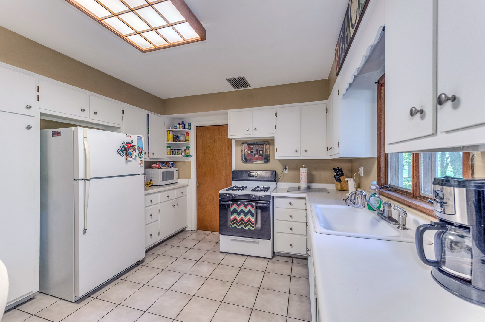 810 Parkside Road Naperville, IL 60540 - Photo 5 of 24 a kitchen with refrigerator cabinets and a stove top oven