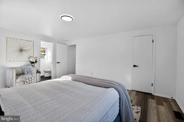 a bedroom with a bed and a painting on the wall