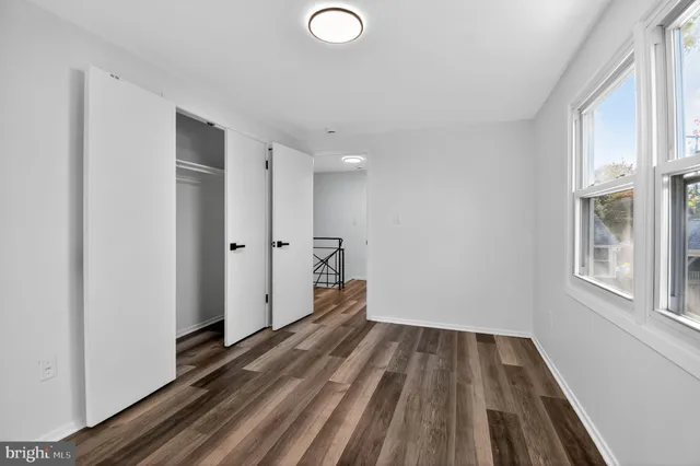 a view of a room with wooden floor and window
