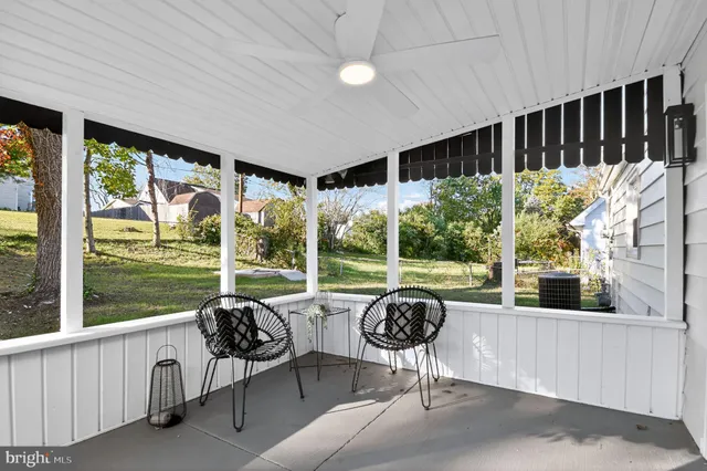 a living room with patio furniture and garden view