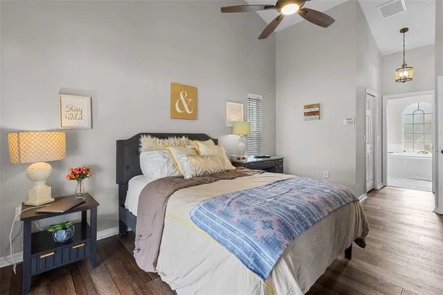 a bedroom with bed and a chandelier