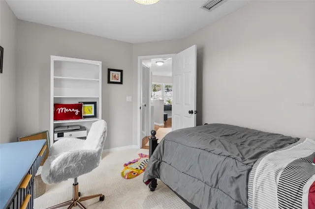 a bed room with a bed and a chair