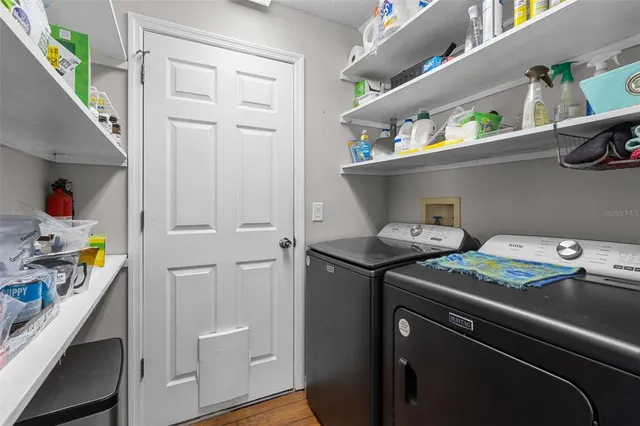 a utility room with cabinets washer and dryer