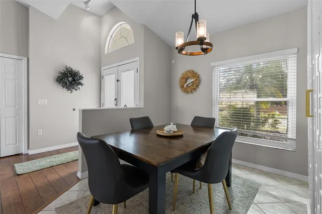 a view of a dining room with a table and chairs