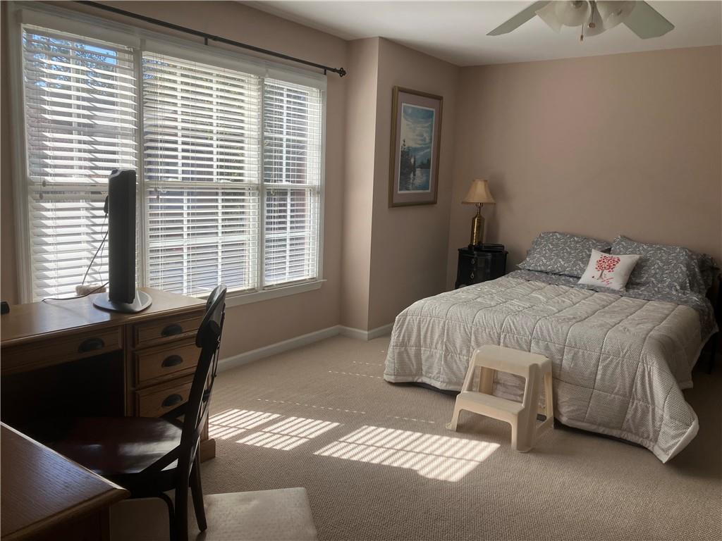 1665 Oakbrook Lake Drive Northwest Norcross, GA 30093 - Photo 11 of 24 a bedroom with a bed and a window