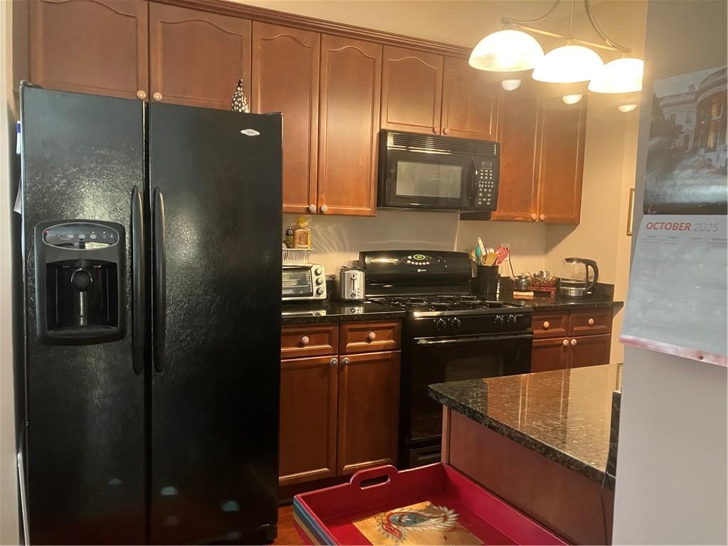 1665 Oakbrook Lake Drive Northwest Norcross, GA 30093 - Photo 14 of 24 a kitchen with stainless steel appliances granite countertop a refrigerator stove and sink
