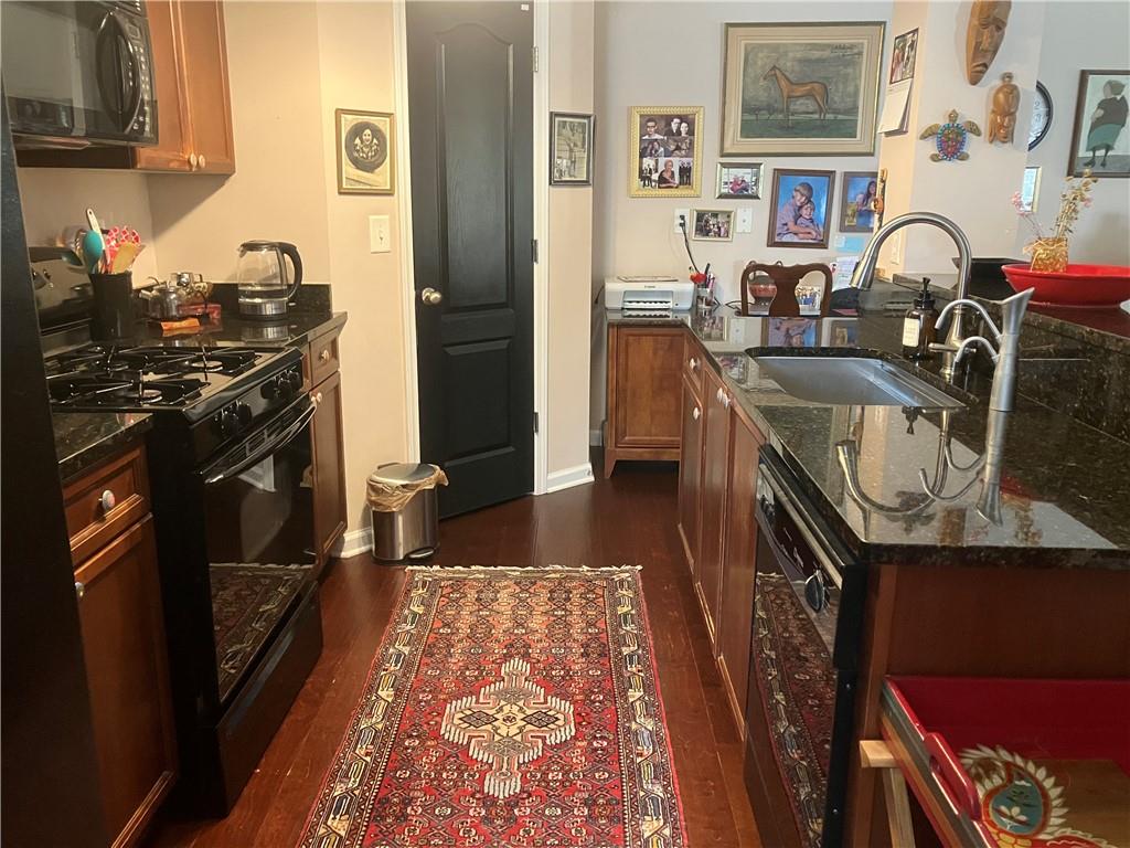 1665 Oakbrook Lake Drive Northwest Norcross, GA 30093 - Photo 15 of 24 a kitchen with stainless steel appliances granite countertop a sink stove and refrigerator