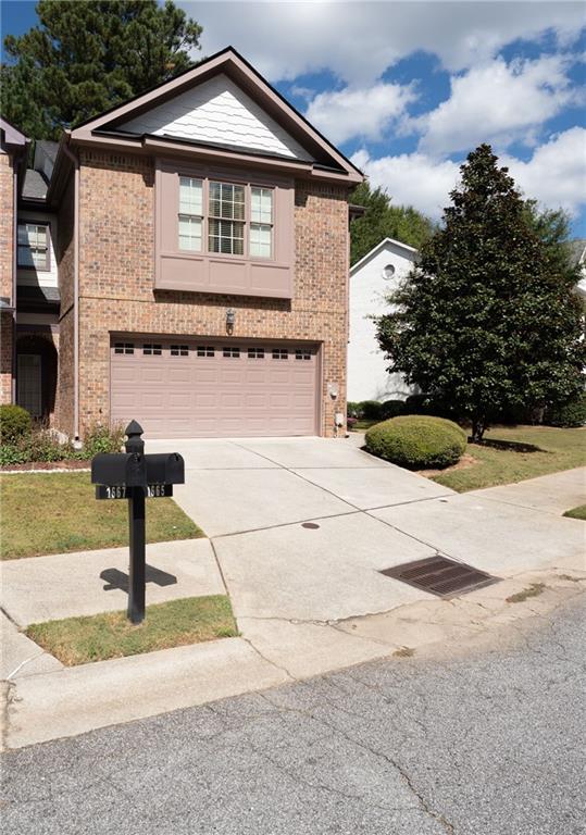 1665 Oakbrook Lake Drive Northwest Norcross, GA 30093 - Photo 2 of 24 a front view of a house with garden